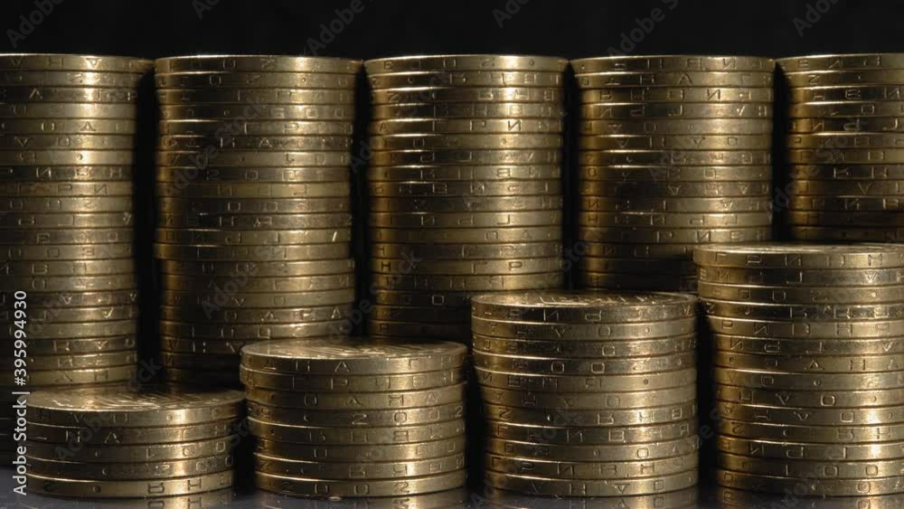 Stacks of coins close up. The graph is high. Profit growth.