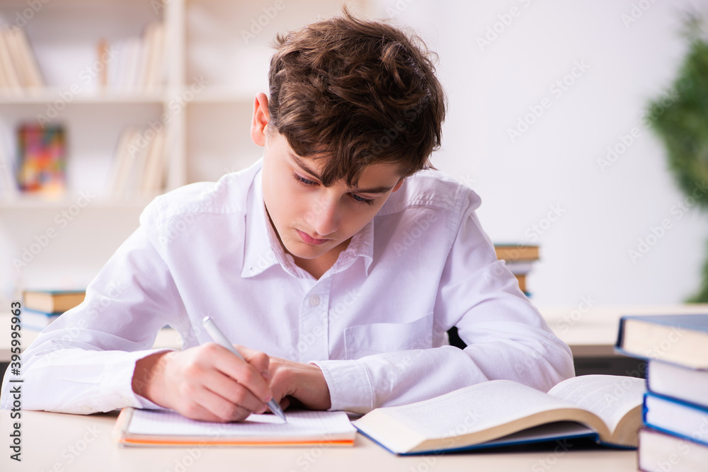 Schoolboy preparing for exams in the classroom Schoolboy preparing for exams in the classroom
