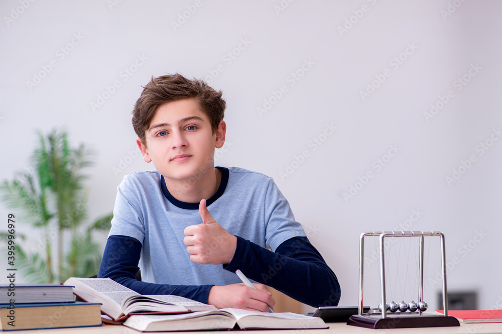 Schoolboy studying physics at home Schoolboy studying physics at home