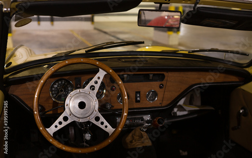 Detail of a vintage dashboard of a convertible sports car from the 60s © willbrasil21