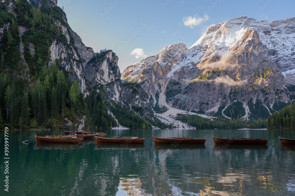 Autumn landscape of Lago di Braies Lake in italian Dolomites mountains in northern Italy. Drone aerial photo with Wooden boats and beautiful reflection in calm water at sunrise. Pragser Wildsee Autumn landscape of Lago di Braies Lake in italian Dolomites mountains in northern Italy. Drone aerial photo with Wooden boats and beautiful reflection in calm water at sunrise. Pragser Wildsee
