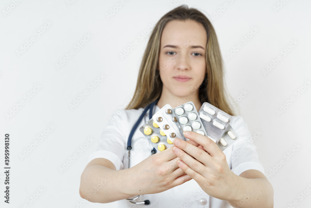 Medicine and health concept. Doctor woman holds pills in hands.
