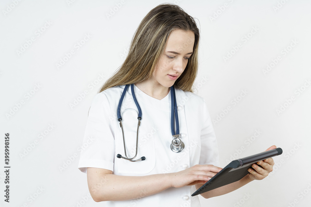 Medicine and health concept. The doctor writes the information into the tablet. Medicine and health concept. The doctor writes the information into the tablet.