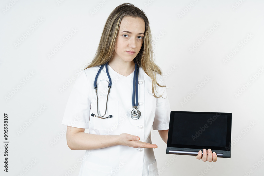 Medicine and health concept. Doctor pointing with his hand to the tablet. Medicine and health concept. Doctor pointing with his hand to the tablet.