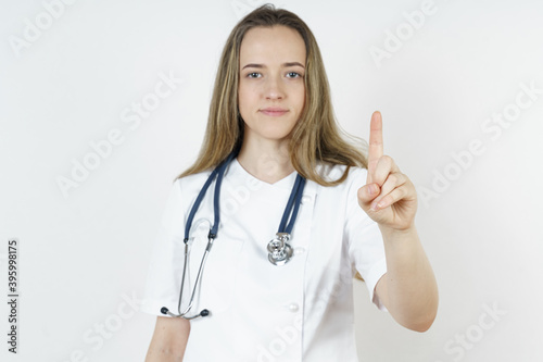 Medicine and health concept. Doctor pointing his finger into space.