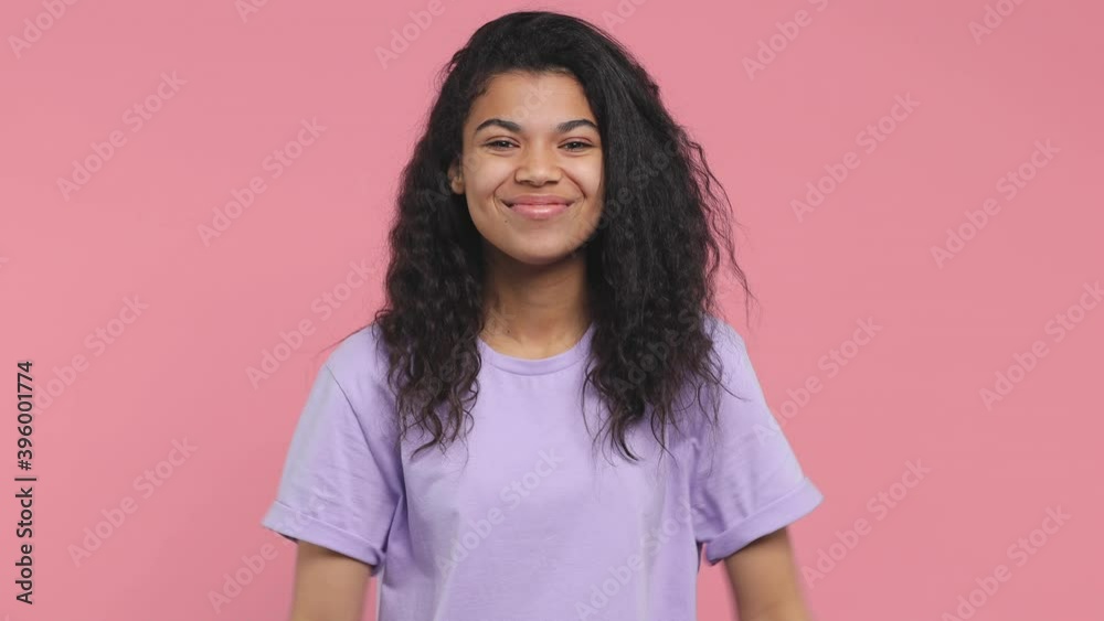 Cheerful smiling young african american woman 20s in casual violet t-shirt posing isolated on pink background studio. People lifestyle concept. Pointing index fingers thumbs on herself looking camera Cheerful smiling young african american woman 20s in casual violet t-shirt posing isolated on pink background studio. People lifestyle concept. Pointing index fingers thumbs on herself looking camera