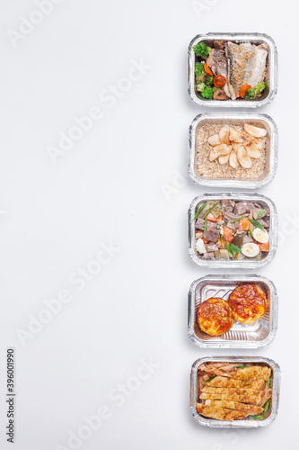 take away lunch boxes with fresh meal in foil container or healthy food delivery