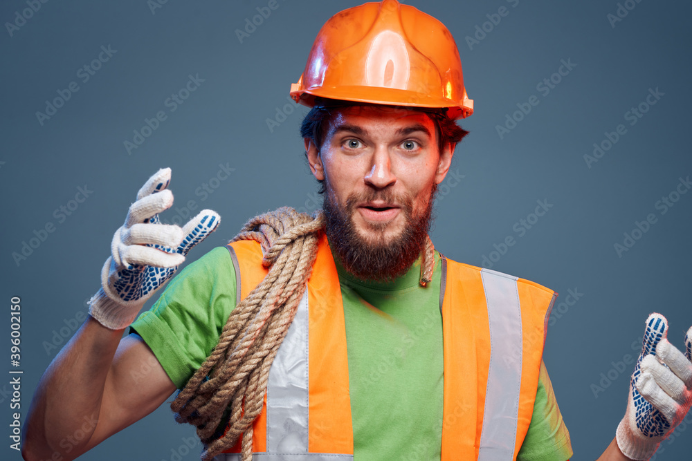 emotional man in work uniform safety professional blue background