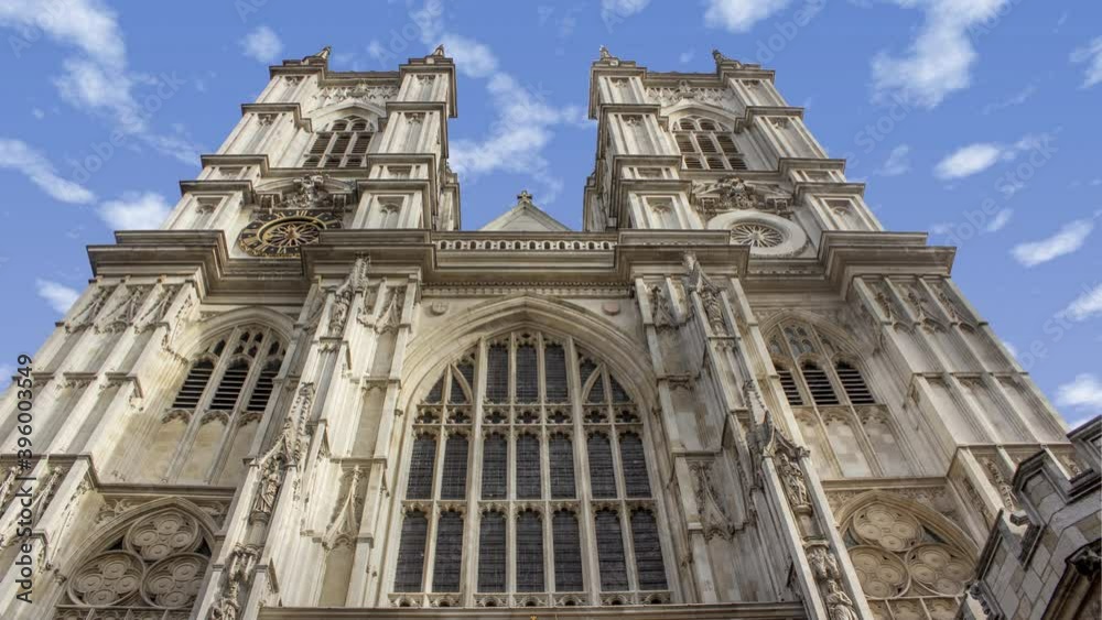 Time lapse of westminster abbey in London United Kingdom during a sunny cloudy day. There is the tower in close up and the clouds in background Time lapse of westminster abbey in London United Kingdom during a sunny cloudy day. There is the tower in close up and the clouds in background