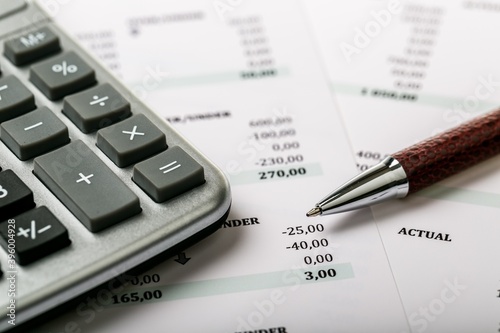 Calculator, Pen and Financial Figures
