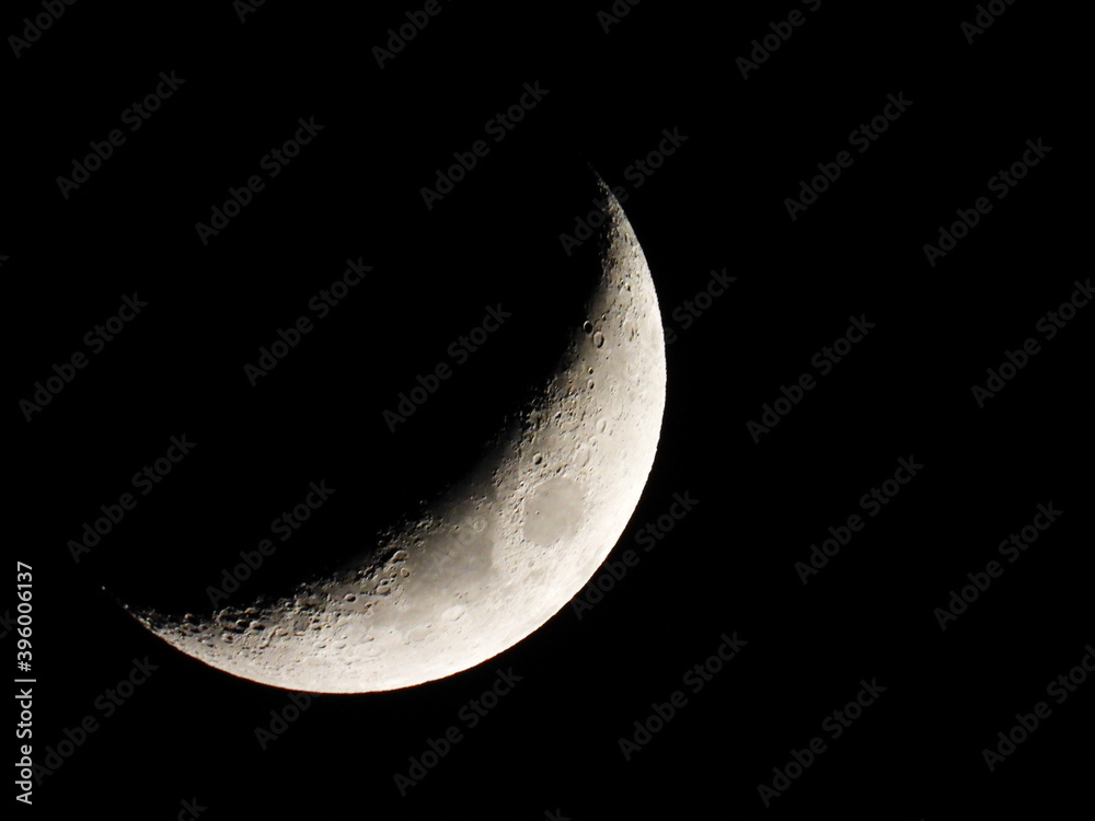 Young growing moon close up against the black sky Young growing moon close up against the black sky