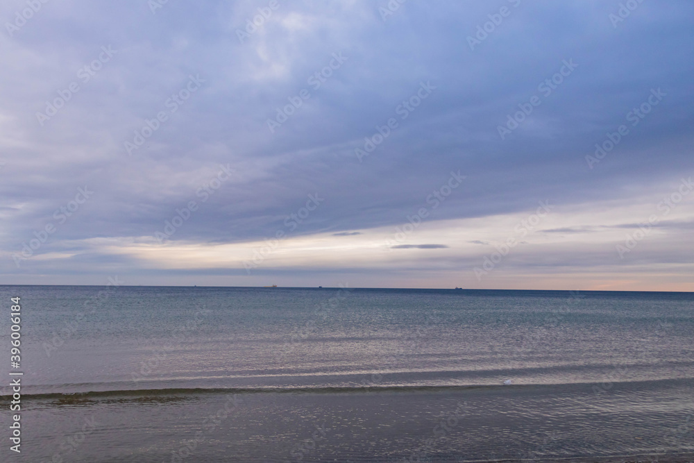 Obraz premium beautiful calm sea waving in the early morning on a golden sandy beach