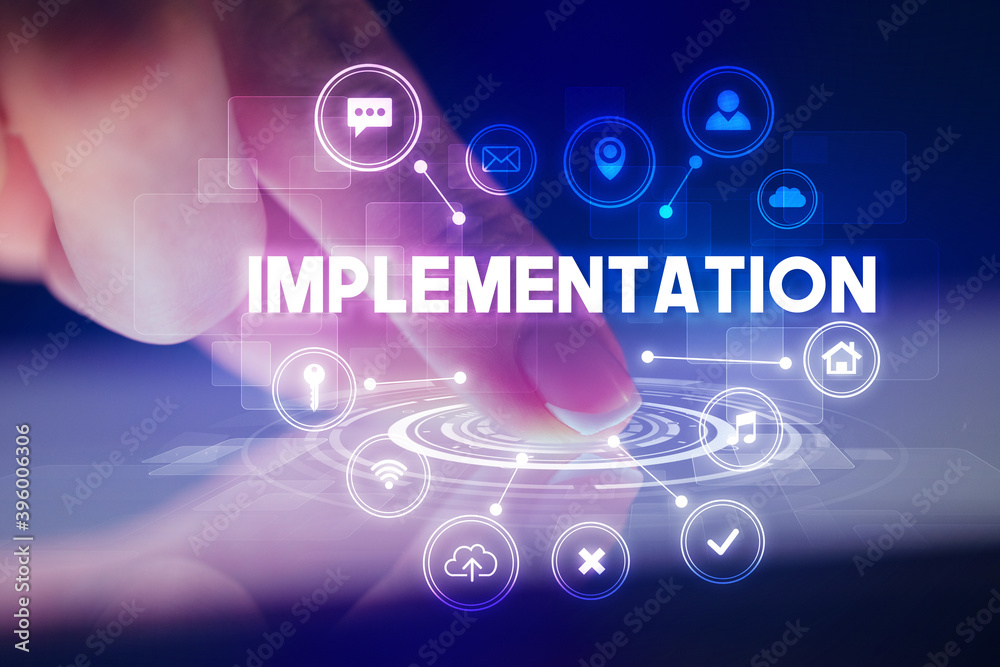 Finger touching tablet with web technology icons and IMPLEMENTATION inscription, web technology concept Finger touching tablet with web technology icons and IMPLEMENTATION inscription, web technology concept