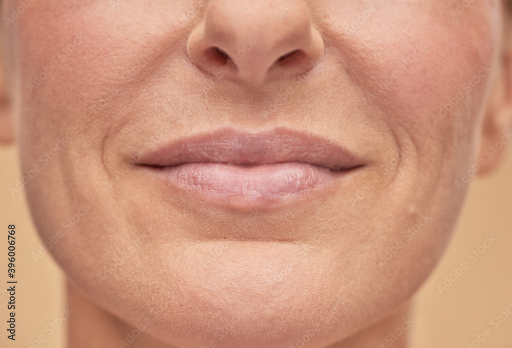 Fototapeta premium Beautiful female face studio shot on a beige background