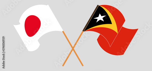 Crossed and waving flags of Japan and East Timor