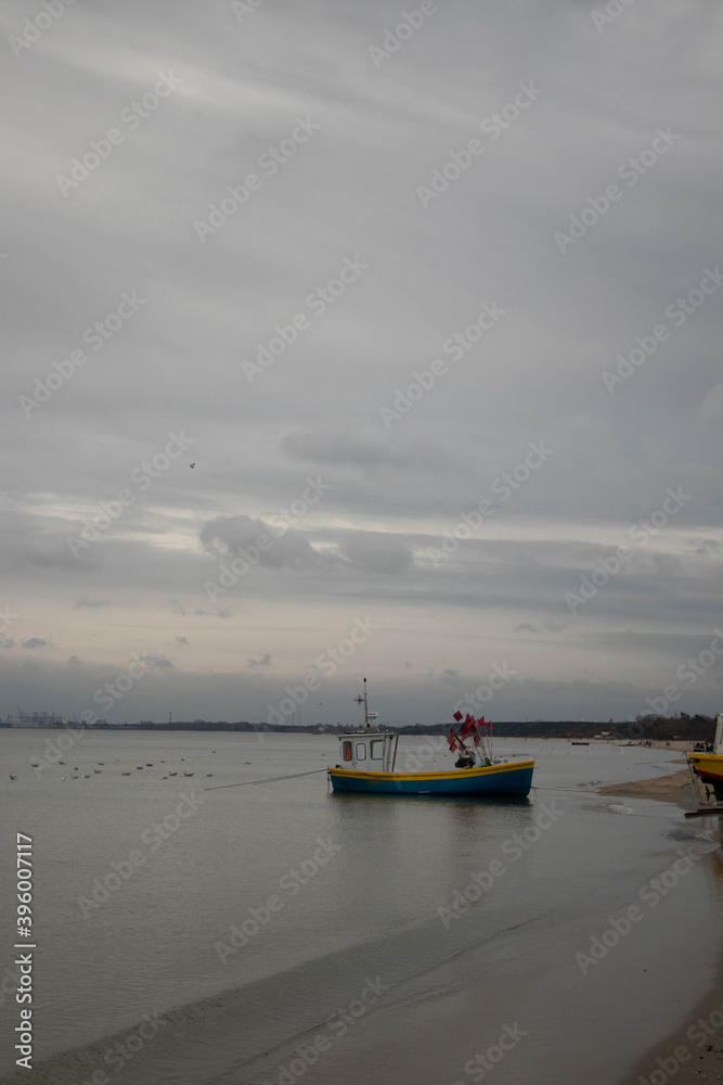  fishing boat standing on the sandy shores of the steel sea