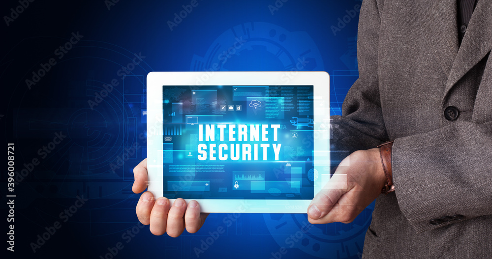 Young business person working on tablet and shows the digital sign: INTERNET SECURITY Young business person working on tablet and shows the digital sign: INTERNET SECURITY