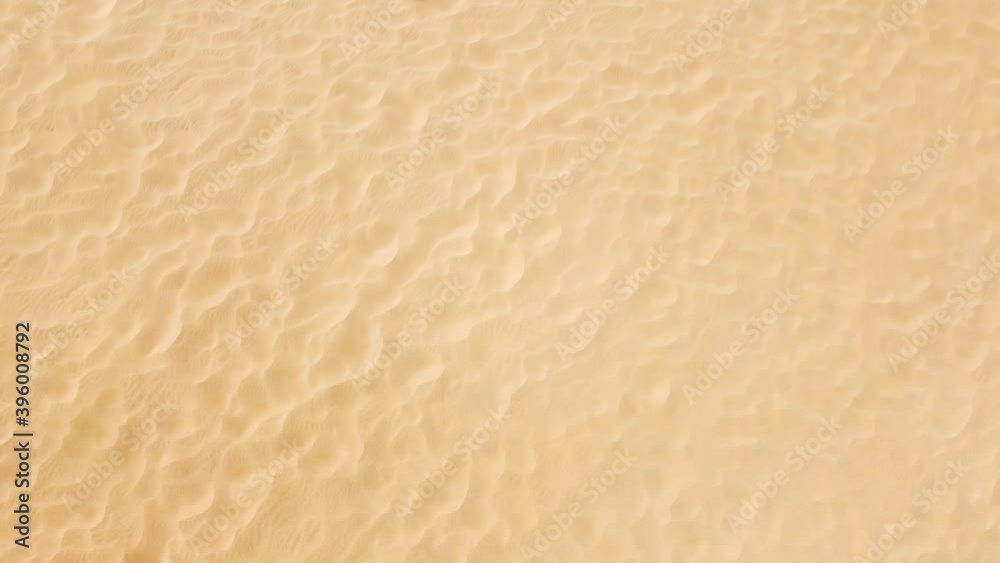 Clean sandy background, texture of the sea summer beach, top view of the sand which covers the entire coast. Clean sandy background, texture of the sea summer beach, top view of the sand which covers the entire coast.