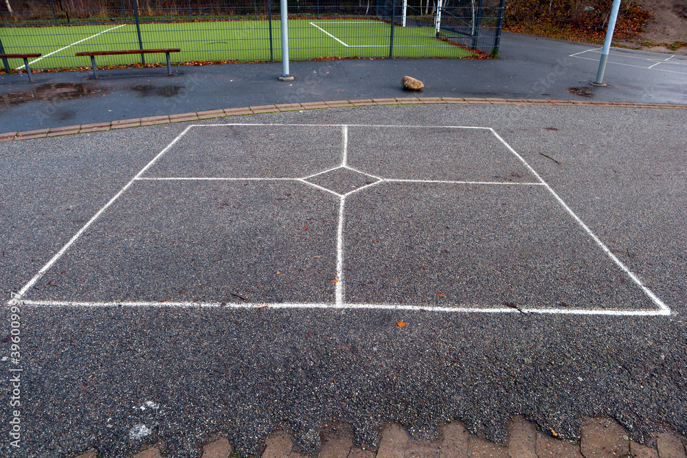 White stripes or lines at asphalt makes a playground in the schoolyard. Outside but no students. Järfälla, Stockholm, Sweden.