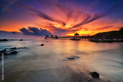 A long exposure picture of majestic sunrise with a jetty as a background at Tanjung Balau, Johore photo