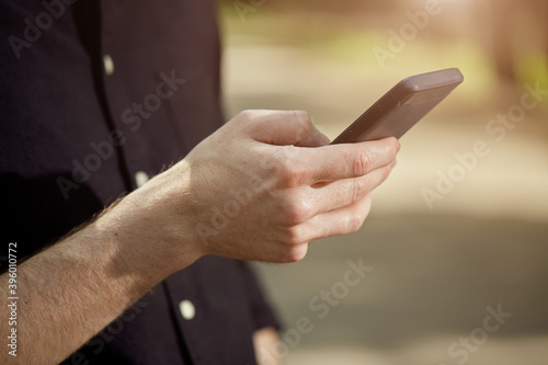 Sending messages, communicating in social networks close - up photo of a hand with a mobile phone.