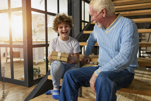 Fotografie Happy grandson receives a gift from grandfather