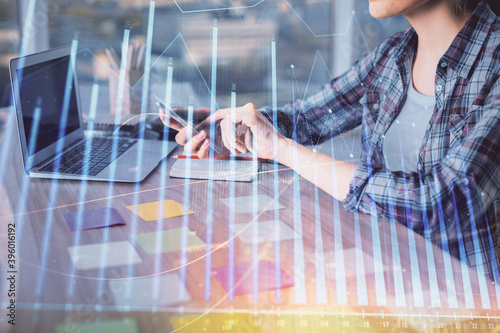 Double exposure of businesswoman hands typing on computer and forex graph hologram drawing. Financial analysis concept.