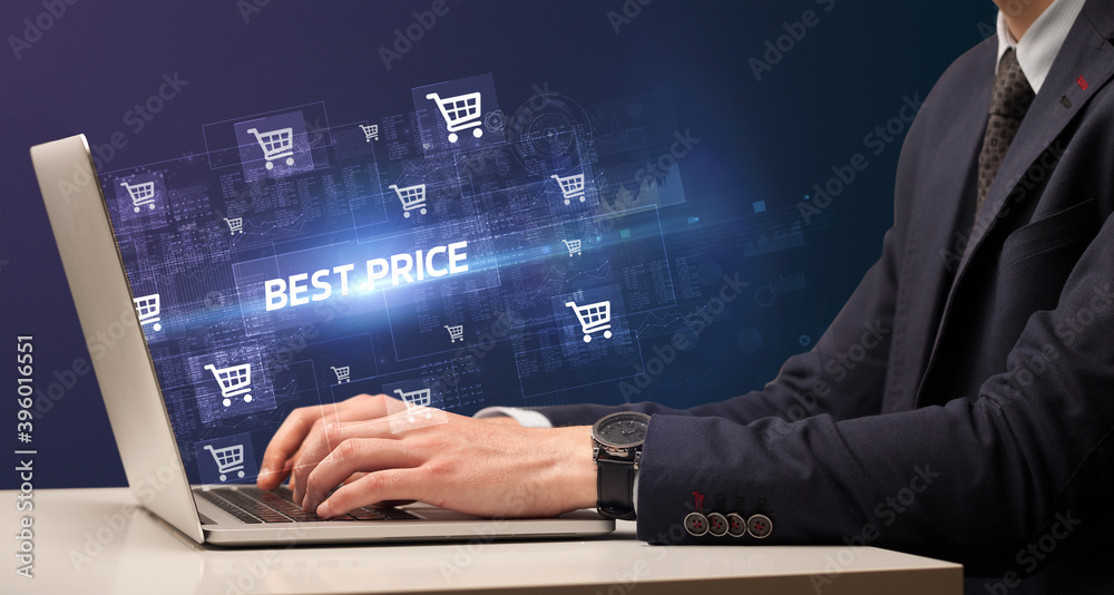 Fototapeta premium Businessman working on laptop with BEST PRICE inscription, online shopping concept