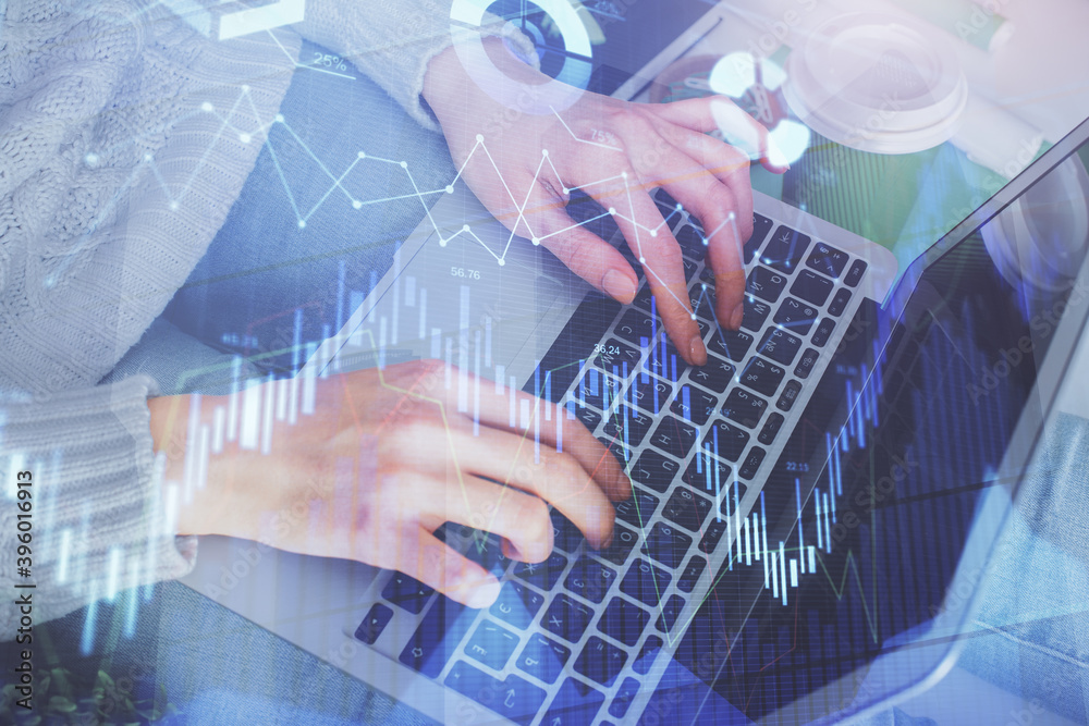 Double exposure of woman hands typing on computer and forex chart hologram drawing. Stock market invest concept.
