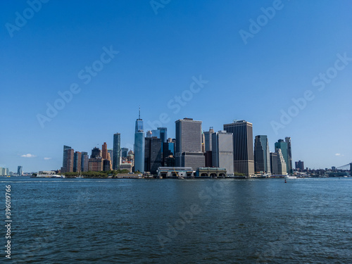 Sunny view of skyscrapers in Financial District, Manhattan from Hudson River with clear sky