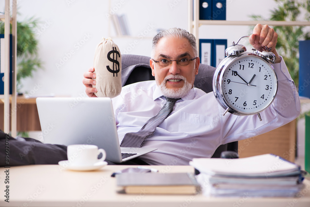 Old male employee in time management concept Old male employee in time management concept