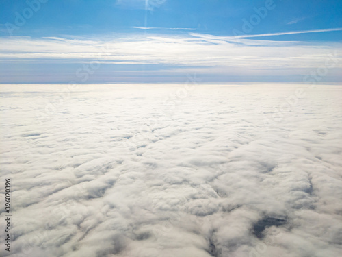 Aerial view above layer of altocumulus clouds on sunny day photo