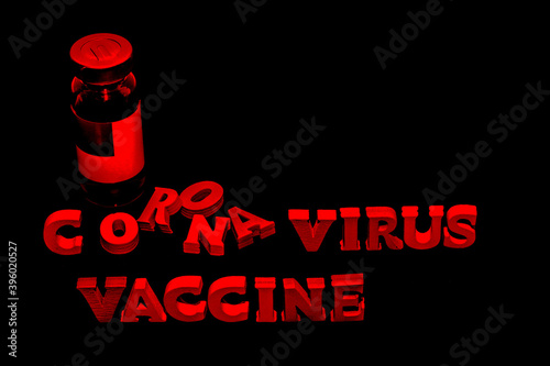 Vial with vaccine on black background, 3d red text corona virus vaccine