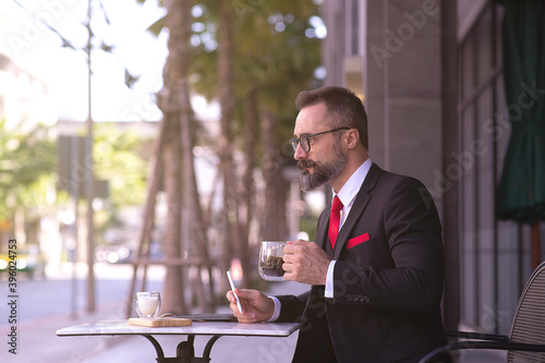 Businessman Check email and Drinking Coffee, Outdoor Coffee Bar, Acting Hipster man, Business Concept.