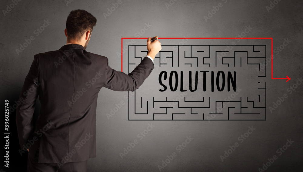 businessman drawing maze with SOLUTION inscription, business education concept