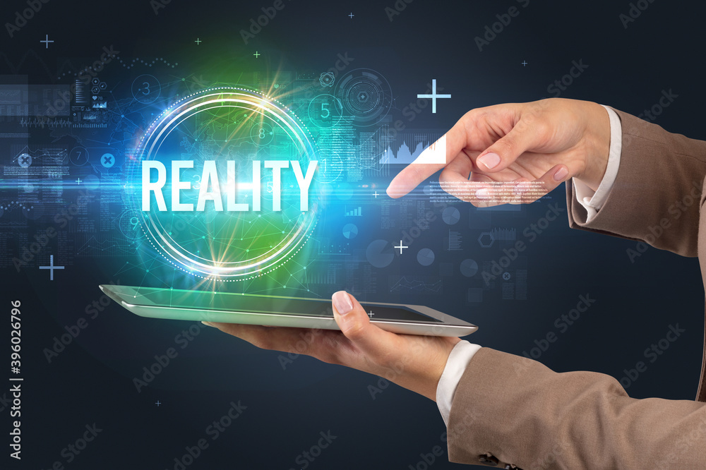 Close-up of a touchscreen with REALITY inscription, new technology concept Close-up of a touchscreen with REALITY inscription, new technology concept