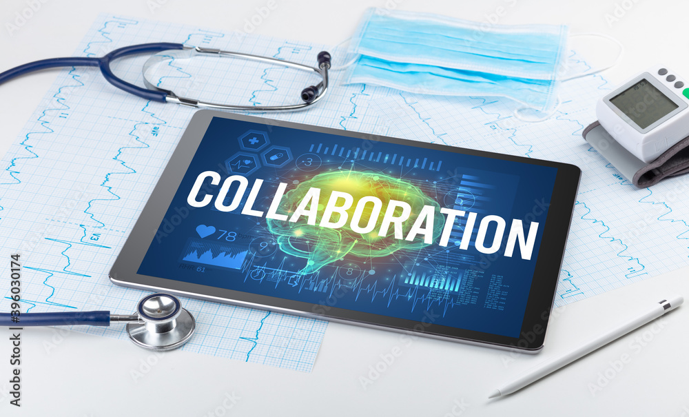 Tablet pc and medical tools with COLLABORATION inscription, social distancing concept Tablet pc and medical tools with COLLABORATION inscription, social distancing concept