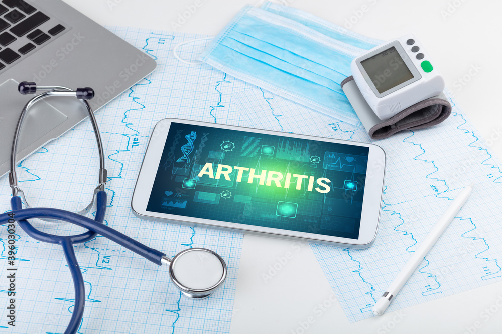 Tablet pc and medical stuff with ARTHRITIS inscription, prevention concept Tablet pc and medical stuff with ARTHRITIS inscription, prevention concept