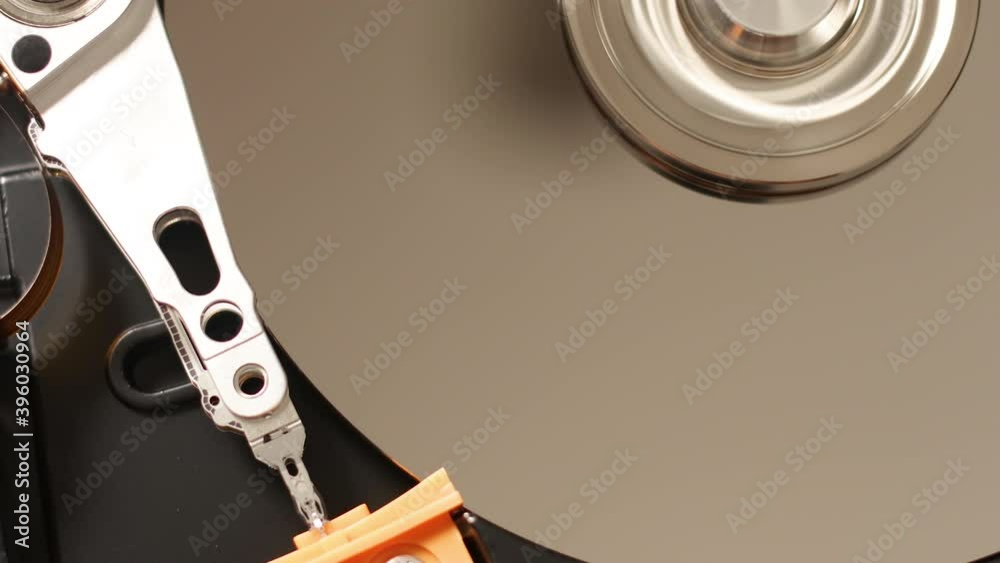 Macro close up of working opened hdd drive hard disk, move of writing, reading magnetic head Macro close up of working opened hdd drive hard disk, move of writing, reading magnetic head