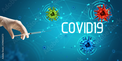 Syringe  medical injection in hand with COVID19 inscription  coronavirus vaccine concept
