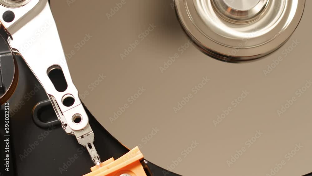 Macro close up of working opened hdd drive hard disk, move of writing, reading magnetic head Macro close up of working opened hdd drive hard disk, move of writing, reading magnetic head