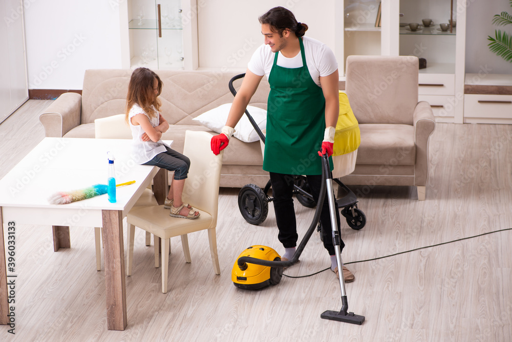 Young male contractor cleaning the house with his small daughter