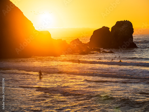 Surfers at Rockaway Beach in Pacifica During Sunset