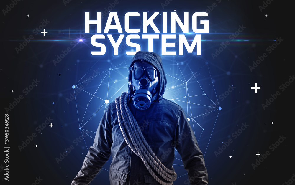 Mysterious hacker with HACKING SYSTEM inscription, online attack concept inscription, online security concept Mysterious hacker with HACKING SYSTEM inscription, online attack concept inscription, online security concept