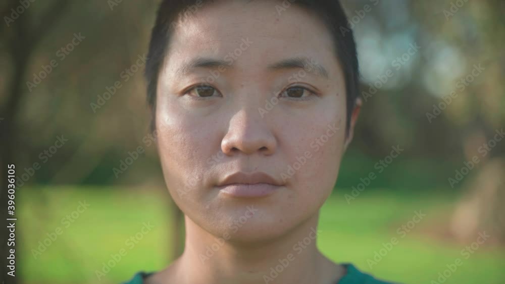 Portrait of a woman taking off a green medical mask, protection against contagious disease, coronavirus, COVID-19 Portrait of a woman taking off a green medical mask, protection against contagious disease, coronavirus, COVID-19