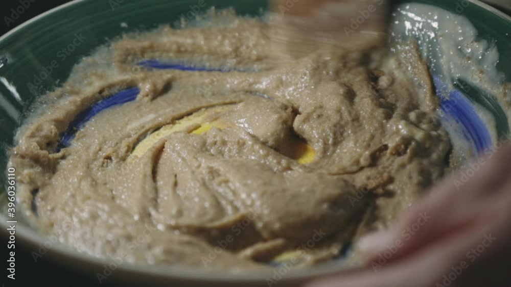 Mixing Cookie Batter By Hand Using A Wooden Spoon. - close up Mixing Cookie Batter By Hand Using A Wooden Spoon. - close up