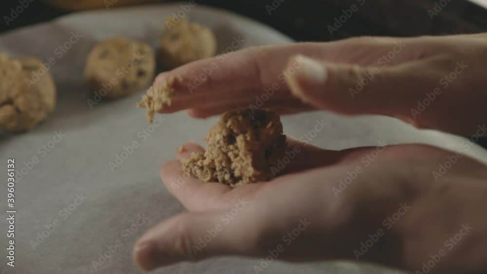 Baker's Hands Rolling Chocolate Chip Cookie For Baking In The Kitchen - close up Baker's Hands Rolling Chocolate Chip Cookie For Baking In The Kitchen - close up