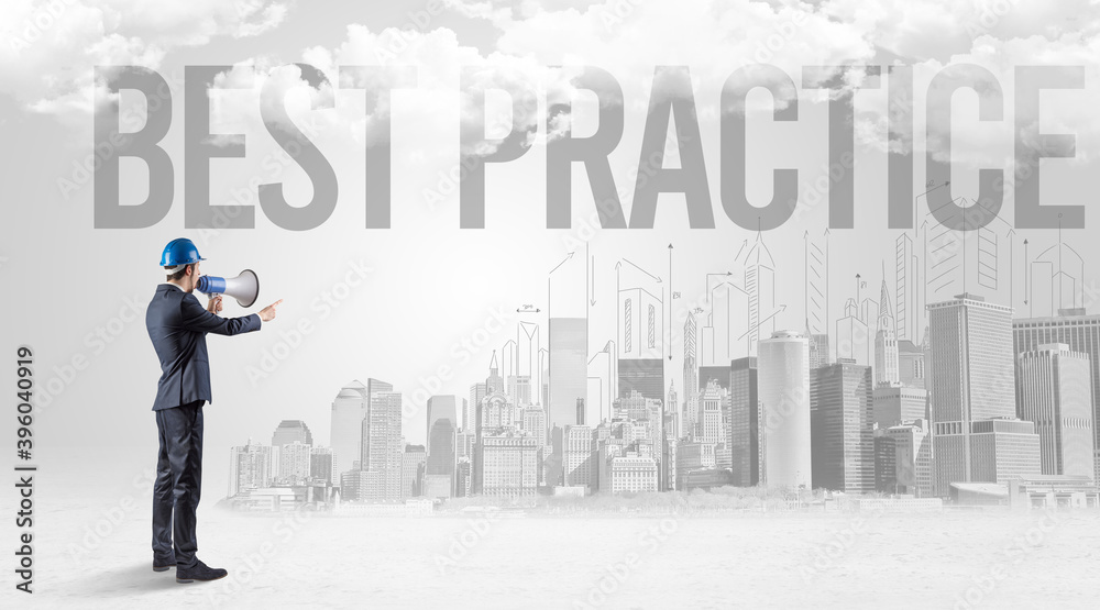Young businessman with hard hat and BEST PRACTICE inscription, new business opportunity concept Young businessman with hard hat and BEST PRACTICE inscription, new business opportunity concept
