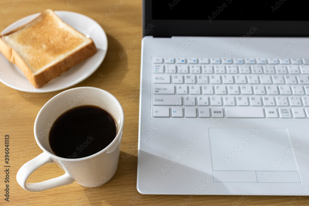 朝食を食べながら、ノートパソコンを使う、イメージ 朝食を食べながら、ノートパソコンを使う、イメージ