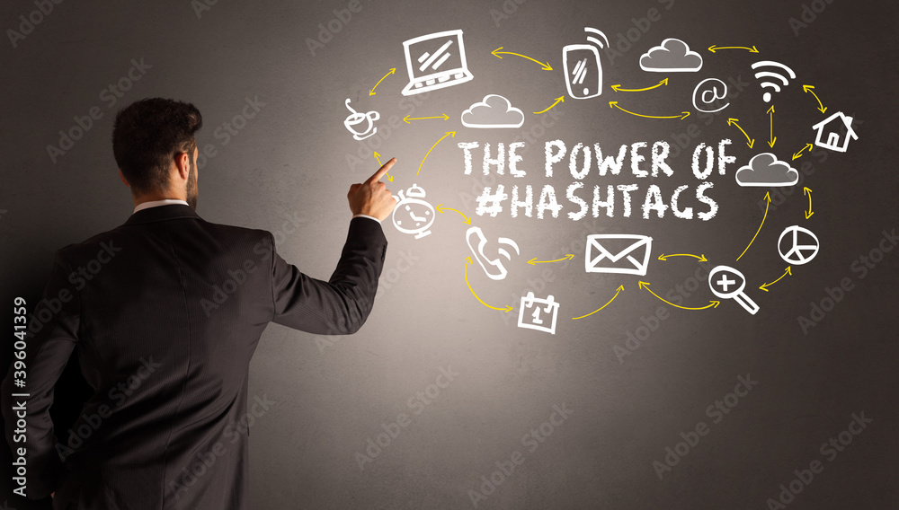 businessman drawing social media icons with THE POWER OF #HASHTAGS inscription, new media concept businessman drawing social media icons with THE POWER OF #HASHTAGS inscription, new media concept